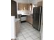 Kitchen with white tile floors, stainless steel refrigerator, and ample cabinet storage at 9000 Las Vegas Blvd # 2097, Las Vegas, NV 89123