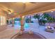 Outdoor living space with a covered patio, pool, spa, string lights, and seating at 9615 Sedona Hills Ct, Las Vegas, NV 89147