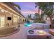 Relaxing outdoor space with a covered patio, pool, spa, and fire pit at 9615 Sedona Hills Ct, Las Vegas, NV 89147