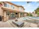Back of home with a covered patio, outdoor seating, barbeque, pool and spa at 9615 Sedona Hills Ct, Las Vegas, NV 89147