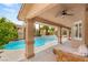 Backyard oasis featuring a pool, spa, covered patio, and ample seating area at 9615 Sedona Hills Ct, Las Vegas, NV 89147