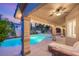 A covered patio overlooks a stunning backyard pool and spa, perfect for outdoor relaxation at 9615 Sedona Hills Ct, Las Vegas, NV 89147