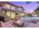 Beautifully landscaped backyard with a pool, spa, covered patio, and outdoor grill at 9615 Sedona Hills Ct, Las Vegas, NV 89147