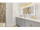 This bright bathroom features dual sinks, modern lighting, and neutral decor at 9615 Sedona Hills Ct, Las Vegas, NV 89147