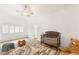 Bright bedroom features a ceiling fan and plush rug and is staged with a crib and charming toys at 9615 Sedona Hills Ct, Las Vegas, NV 89147