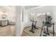 Bonus room with fitness equipment and view to primary bath featuring a soaking tub and ample light at 9615 Sedona Hills Ct, Las Vegas, NV 89147
