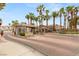 Elegant gated community entrance featuring lush palm trees and meticulously maintained landscaping at 9615 Sedona Hills Ct, Las Vegas, NV 89147
