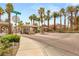 Palm trees line a gated community entrance at Katie Ave offering security and curb appeal at 9615 Sedona Hills Ct, Las Vegas, NV 89147