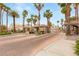 Well-maintained gated community entrance with beautiful palm trees and inviting landscaping at 9615 Sedona Hills Ct, Las Vegas, NV 89147