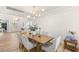 Open concept dining area featuring stylish light fixture and view to front entry of the home at 9615 Sedona Hills Ct, Las Vegas, NV 89147