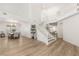 Spacious entry with elegant staircase, light wood floors and access to dining and living areas at 9615 Sedona Hills Ct, Las Vegas, NV 89147