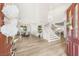 Grand entryway with high ceilings, curved staircase, and views of the dining and living areas at 9615 Sedona Hills Ct, Las Vegas, NV 89147