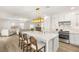 Open kitchen featuring large island with seating, white cabinets, stainless appliances, and view into the living room at 9615 Sedona Hills Ct, Las Vegas, NV 89147