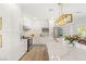 Bright kitchen with stainless steel appliances, white cabinetry, and large center island with marble countertops at 9615 Sedona Hills Ct, Las Vegas, NV 89147