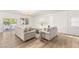 Bright living room with white walls, modern light fixture, and sliding glass door to patio at 9615 Sedona Hills Ct, Las Vegas, NV 89147