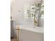 Close up of a soaking tub in the primary bathroom showcasing elegant gold fixtures and shuttered window at 9615 Sedona Hills Ct, Las Vegas, NV 89147