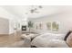 Spacious main bedroom with fireplace, wood-look floors, seating area, shuttered windows and view to bath at 9615 Sedona Hills Ct, Las Vegas, NV 89147