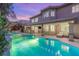 Serene backyard with a pool, spa, covered patio, and lush landscaping at 9615 Sedona Hills Ct, Las Vegas, NV 89147