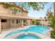 Inviting backyard with a sparkling pool, spa, covered patio, and lush landscaping at 9615 Sedona Hills Ct, Las Vegas, NV 89147