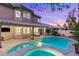 Inviting backyard with a sparkling pool, spa, covered patio, and lush landscaping at 9615 Sedona Hills Ct, Las Vegas, NV 89147