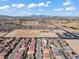 Aerial view of a neighborhood, set against a backdrop of mountains and clear blue skies with sparse white clouds at 9742 Toad Hollow St, Las Vegas, NV 89141