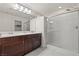 Bathroom featuring dual sinks, white countertops, and a glass-enclosed shower at 9742 Toad Hollow St, Las Vegas, NV 89141