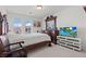 Bright bedroom with dark wood furniture, modern TV, and soft white carpet at 9742 Toad Hollow St, Las Vegas, NV 89141
