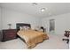 Spacious bedroom with a bed, dresser, recliner, and attached ensuite bathroom at 9742 Toad Hollow St, Las Vegas, NV 89141