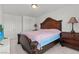 Bedroom features a large wooden bed frame, carpet, and neutral-colored walls at 9742 Toad Hollow St, Las Vegas, NV 89141