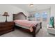 Bright bedroom with dark wood furniture, modern TV, and soft white carpet at 9742 Toad Hollow St, Las Vegas, NV 89141