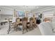 An elegant dining room with a large table and chairs, a chandelier, and artwork at 9742 Toad Hollow St, Las Vegas, NV 89141
