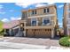 Two-story home showcasing a private balcony, two-car garage, and tiled roof at 9742 Toad Hollow St, Las Vegas, NV 89141