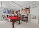 Spacious game room features a pool table, bar stools, and unique wall art at 9742 Toad Hollow St, Las Vegas, NV 89141
