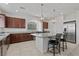 Modern kitchen featuring granite countertops, an island with seating, and stainless steel appliances at 9742 Toad Hollow St, Las Vegas, NV 89141