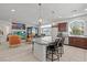 Open kitchen and living space with large island, pendant lights, and tile flooring at 9742 Toad Hollow St, Las Vegas, NV 89141