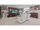 Opulent living room with white furniture, a large TV, and ornate decorations and statues at 9742 Toad Hollow St, Las Vegas, NV 89141