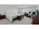 Spacious main bedroom featuring a king bed, wooden furniture, and large windows at 9742 Toad Hollow St, Las Vegas, NV 89141