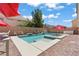 Backyard pool and spa surrounded by brick and shaded by umbrellas at 9742 Toad Hollow St, Las Vegas, NV 89141