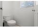 Powder room showcasing white toilet and neutral wall paint at 9742 Toad Hollow St, Las Vegas, NV 89141