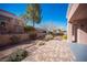 Charming backyard with stone paver patio, mature trees, and terraced landscaping at 9817 Kernville Dr, Las Vegas, NV 89134