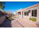 View of side yard and backyard featuring desert landscaping, mature plants, and privacy at 9817 Kernville Dr, Las Vegas, NV 89134