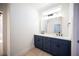 Bathroom featuring double sinks with quartz countertop and ample lighting at 9817 Kernville Dr, Las Vegas, NV 89134