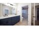 Bathroom with double vanity, quartz countertop, and a glass-enclosed shower at 9817 Kernville Dr, Las Vegas, NV 89134