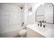 Clean bathroom showcases a tub and shower combo with new fixtures, vanity, and a large arched mirror at 9817 Kernville Dr, Las Vegas, NV 89134