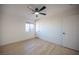 Bedroom with ceiling fan, light wood-look flooring and large window for natural light at 9817 Kernville Dr, Las Vegas, NV 89134