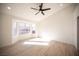 Sunlit bedroom with wood-style flooring and a large bay window at 9817 Kernville Dr, Las Vegas, NV 89134