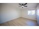 Well lit bedroom with ceiling fan and light wood-look flooring with large windows at 9817 Kernville Dr, Las Vegas, NV 89134