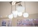 Dining room with modern chandelier and lots of natural light via backyard views at 9817 Kernville Dr, Las Vegas, NV 89134