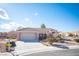 Charming home with desert landscaping, a tile roof, and a two-car garage at 9817 Kernville Dr, Las Vegas, NV 89134