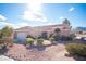 Single-story home has desert landscaping, a two-car garage, and a tile roof at 9817 Kernville Dr, Las Vegas, NV 89134